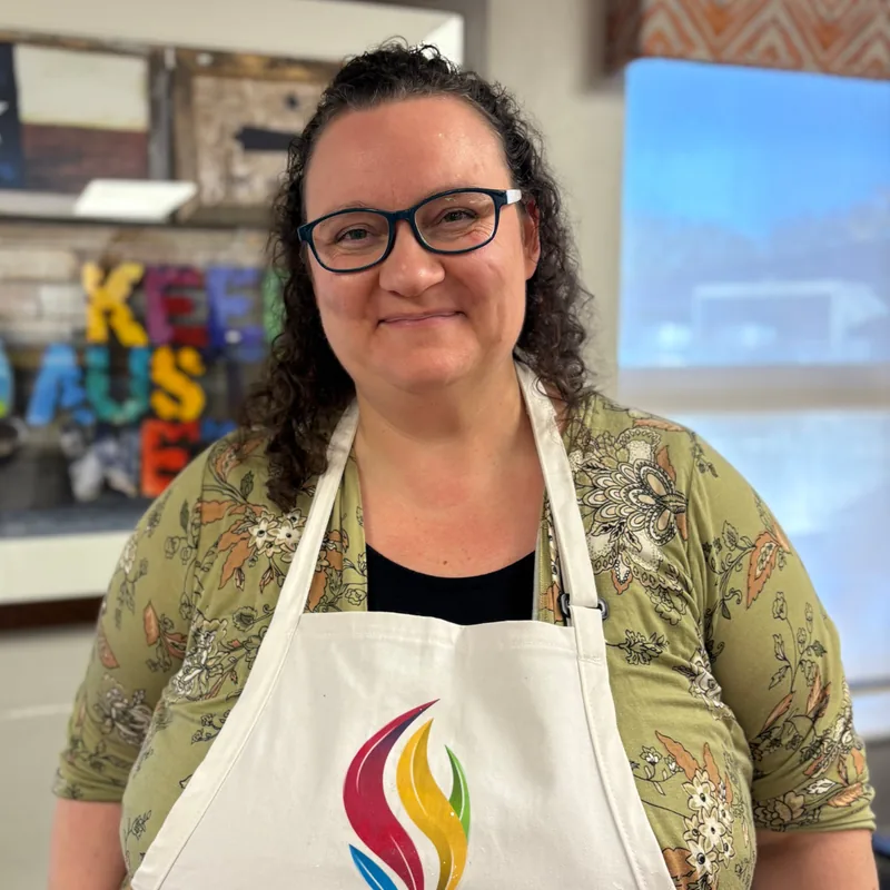 Myranda Harris, Program Director of Joy for Seniors at Artly World, smiling warmly in a professional portrait.